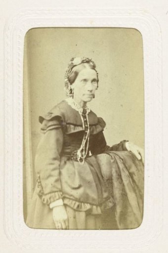 Studio portrait of an older woman dressed in a long black dress