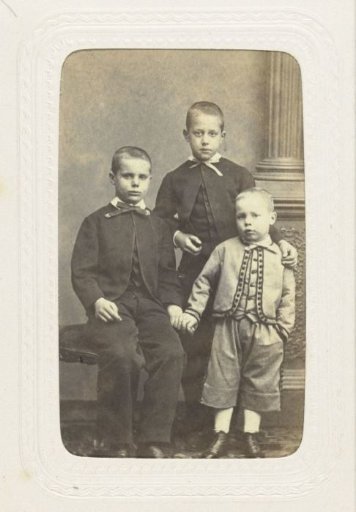 Studio portrait of three boys in suits