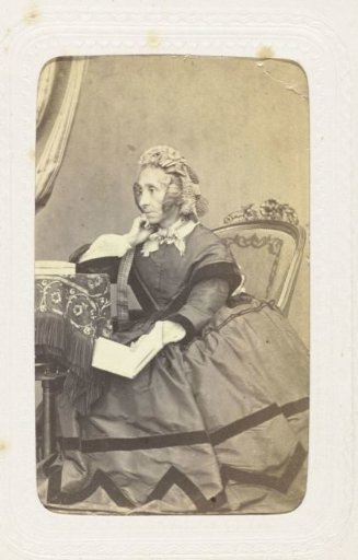 Studio portrait of an older woman in a chair