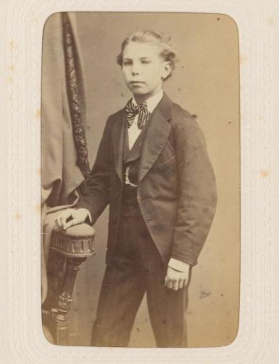 Studio portrait of a boy dressed in a three-piece suit