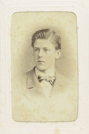 Studio portrait of a young man in a jacket with a checkered bow