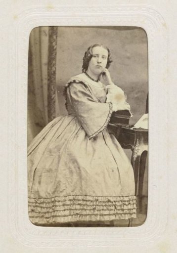 Studio portrait of a woman with ringlets and a full skirt