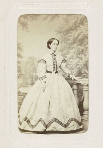 Studio portrait of a young woman in a long dress with spots