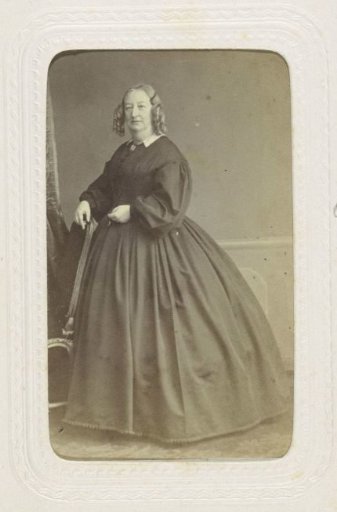 Studio portrait of an older woman in a long black dress