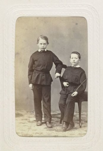 Studio Portrait of Two Boys in Black Suits