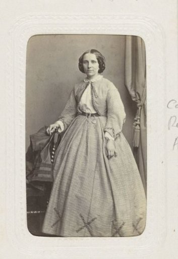 Studio portrait of a woman in a puffed checkered skirt with a matching vest