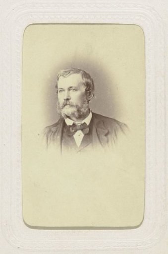 Studio portrait of a man with a mustache and a bow tie