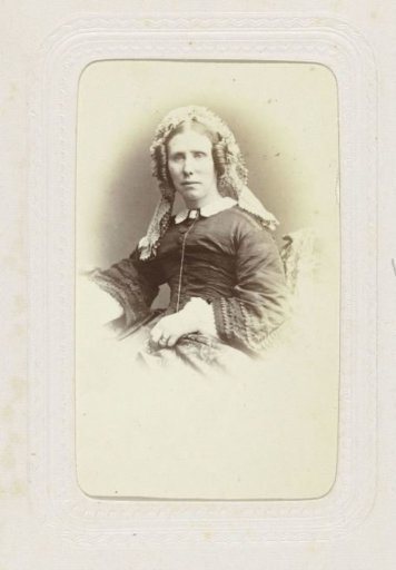 Studio portrait of a woman with braids and a headscarf