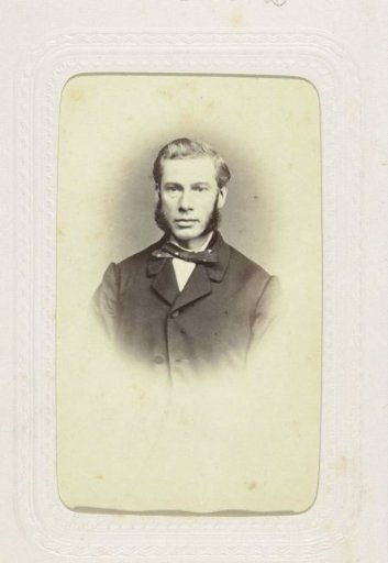 Studio portrait of a man with large sideburns and a bow tie