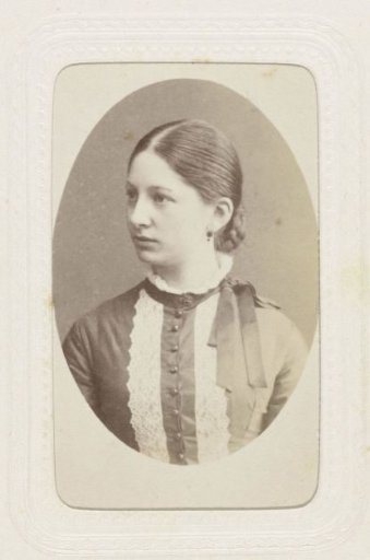 Studio portrait of a young woman in a high-closed dress