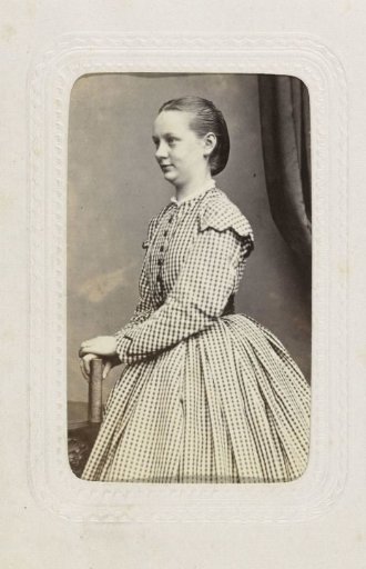 Studio portrait of a woman in a checkered dress