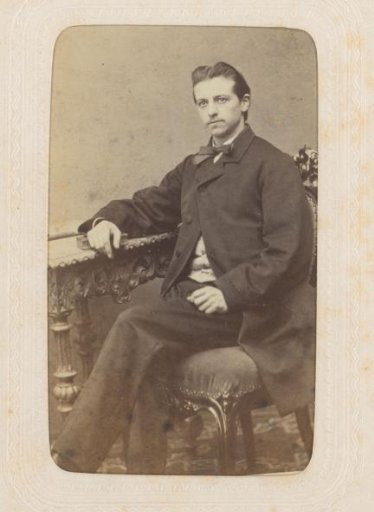 Studio portrait of a man at a table with ornaments