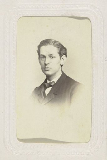 Studio portrait of a young man with a part in his hair and a bow tie