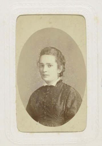 Oval studio portrait of a woman in a dark dress