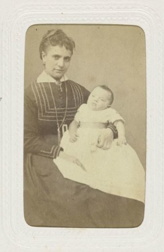 Studio portrait of a woman with a child on her lap