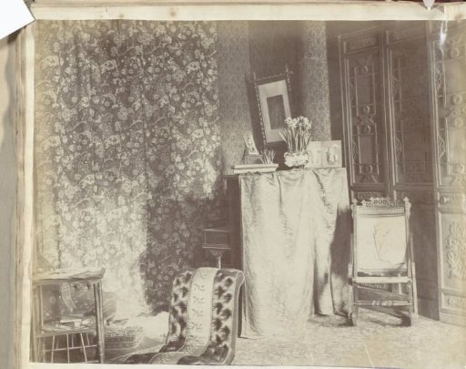 Interior with piano, chairs, side tables and curtains