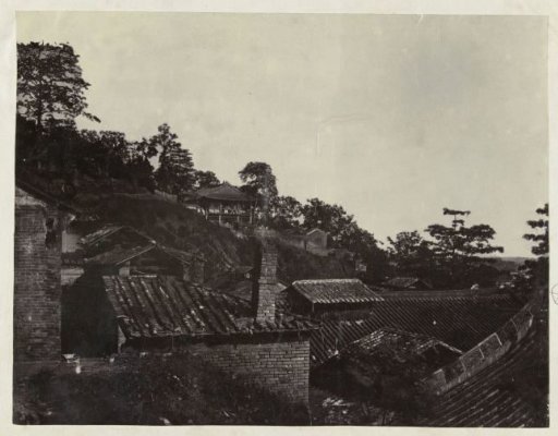 Roofs of houses situated against a hill, China