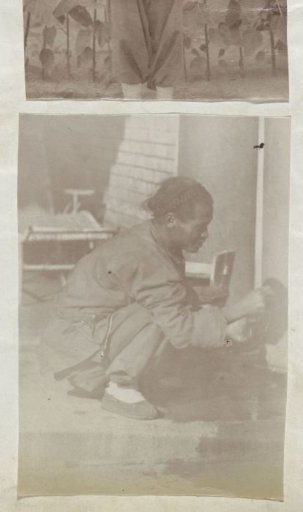 Squatting Chinese Man Cleaning a Pan on the Ground