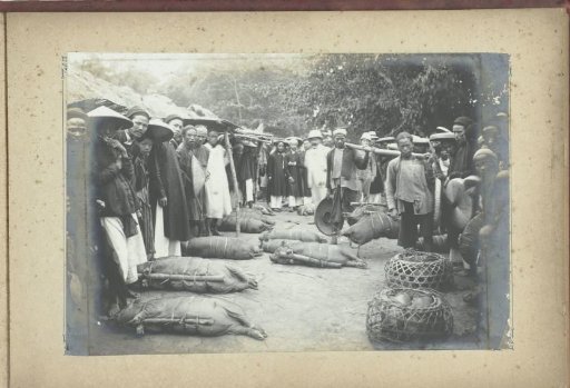 People with captured and tethered pigs, French Indochina