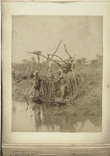 Two Men Pumping Water Up with a Shadoof to Irrigate the Land
