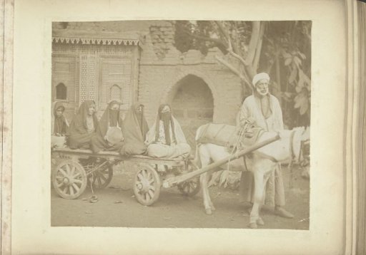 Veiled Women Sitting on a Cart Drawn by a Donkey