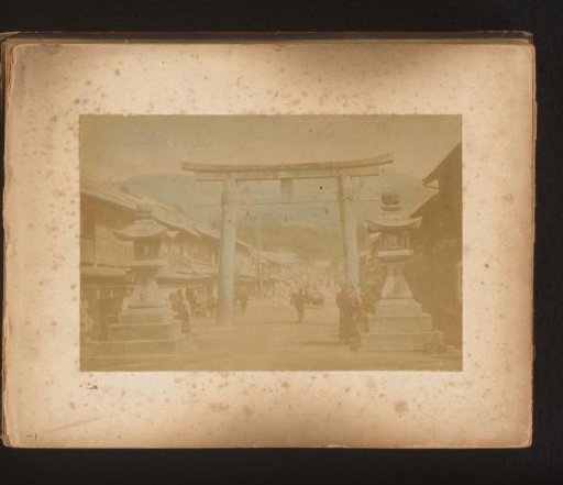 View of the entrance to a Shintō shrine in Japan, with a torii in the foreground