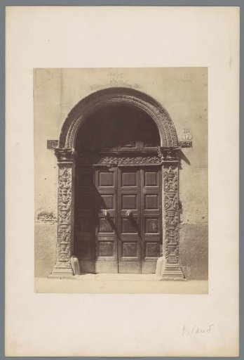 Decorated door of a building in Milan, Italy