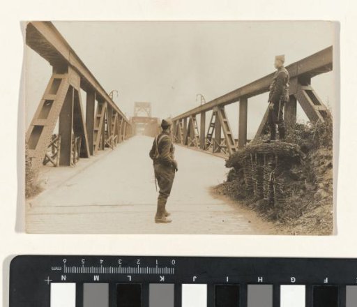 Two soldiers keeping watch on a bridge