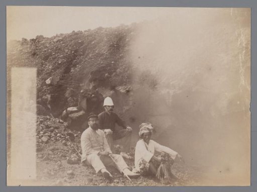 Photo of three men next to a crater during an expedition, Padang, West-Sumatra
