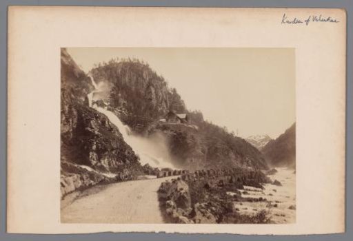 Waterfall along a steep rock with a house nearby, Hardangerfjord [?], Norway