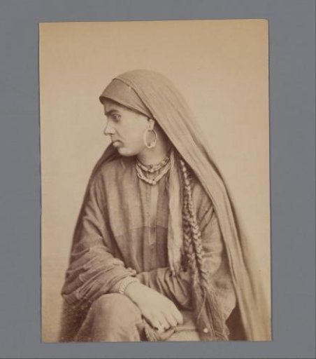 Woman in profile with a headscarf and long braids