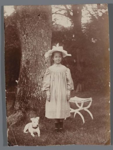 Portrait of an Unknown Girl with a Dog Posing by a Tree