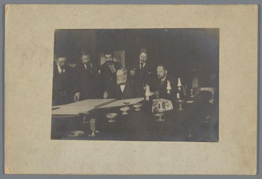 George Hendrik Breitner and Others Viewing a Portfolio, Possibly During an Art Viewing at Arti et Amicitiae