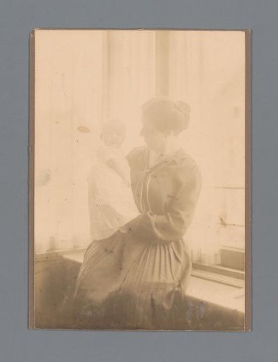 Portrait of an unknown woman with a child by the window