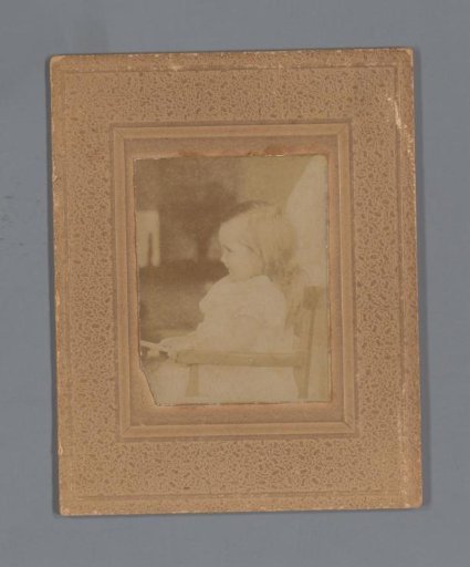 Portrait of an unknown girl in a chair