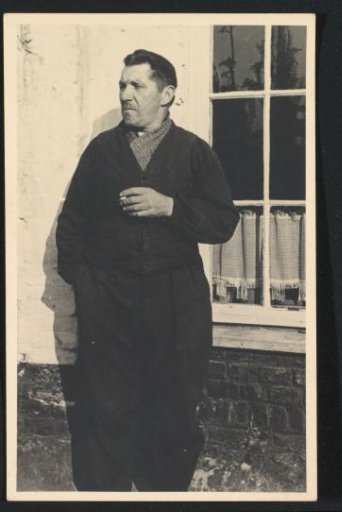 Leopold Desiré Urtebise, father of G.A. Brusse-Urtebise, smoking by a window in a room