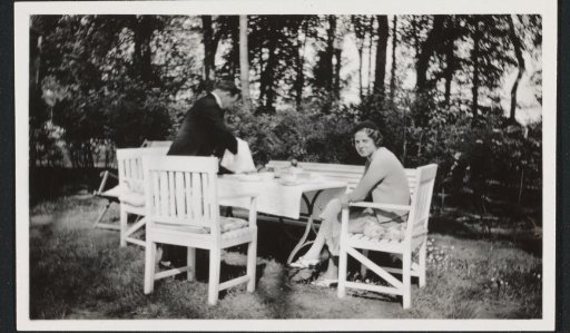 G.A. Brusse-Urtebise at a Table in a Garden with a Serving Waiter in Luxembourg