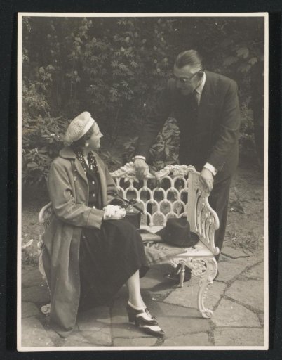 G.A. Brusse-Urtebise Sitting on a Cast-Iron Garden Bench in the Company of a Man at the Keukenhof