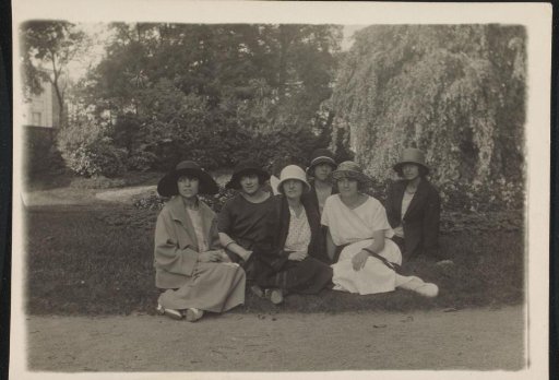 Group Portrait of Six Women with Hats Sitting in the Garden of the Palais des Académies in Brussels