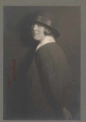 Portrait of G.A. Urtebise standing in an equestrian costume with a bowler hat