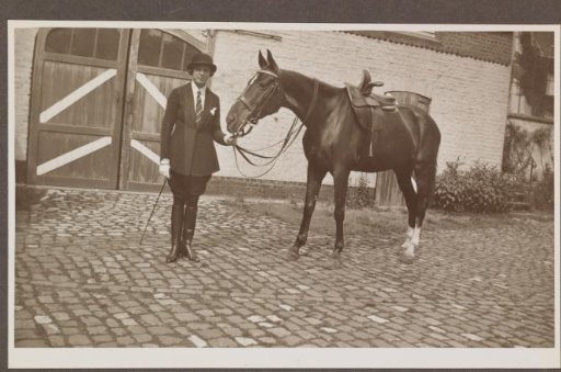 G.A. Urtebise in an equestrian costume standing by a horse