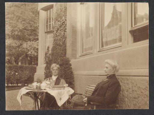 Mrs. Black (right, mother of Mrs. Crone-Black) and Mrs. Crone-Muller, drinking coffee in a garden
