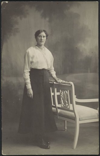 Portrait of Catrien Deursma in a skirt and a blouse, standing