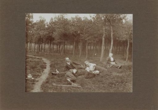 Men, Women, and a Boy Lying on the Grass Along a Path