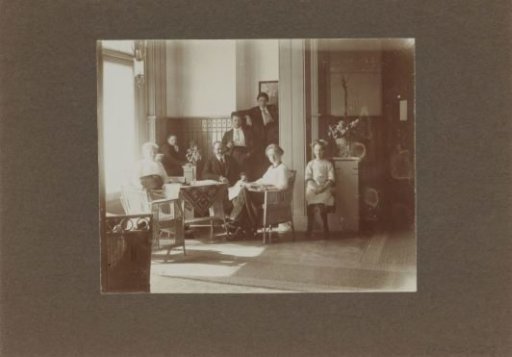 Men, Women, and Children Posing in a Living Room