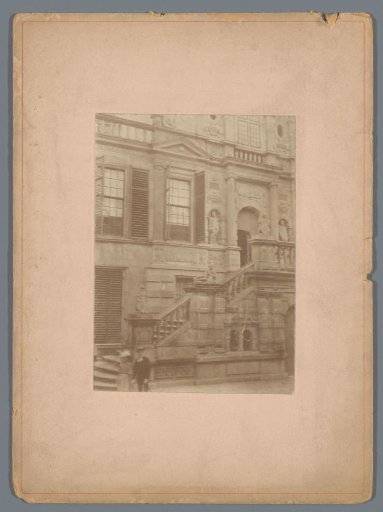 Facade with a Balcony Staircase and a Boy in Front