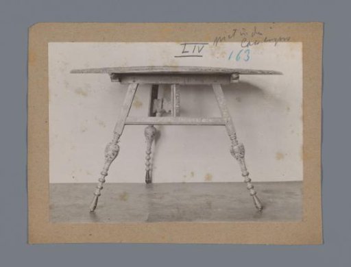 Three-legged table decorated with floral motifs