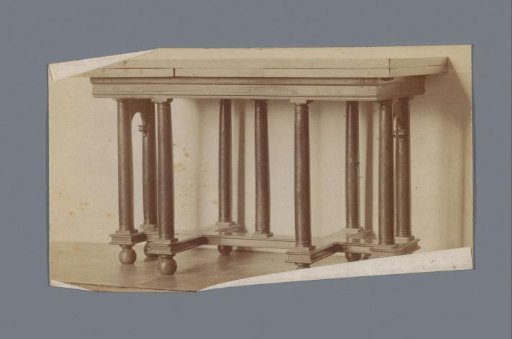 Table with stylized columns as legs resting on balls
