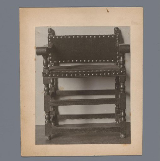 Armchair with rear stiles crowned by human heads