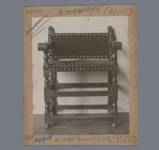 Armchair with rear stiles crowned by human heads